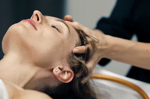 Woman Receiving an Indie Head massage from an RMT